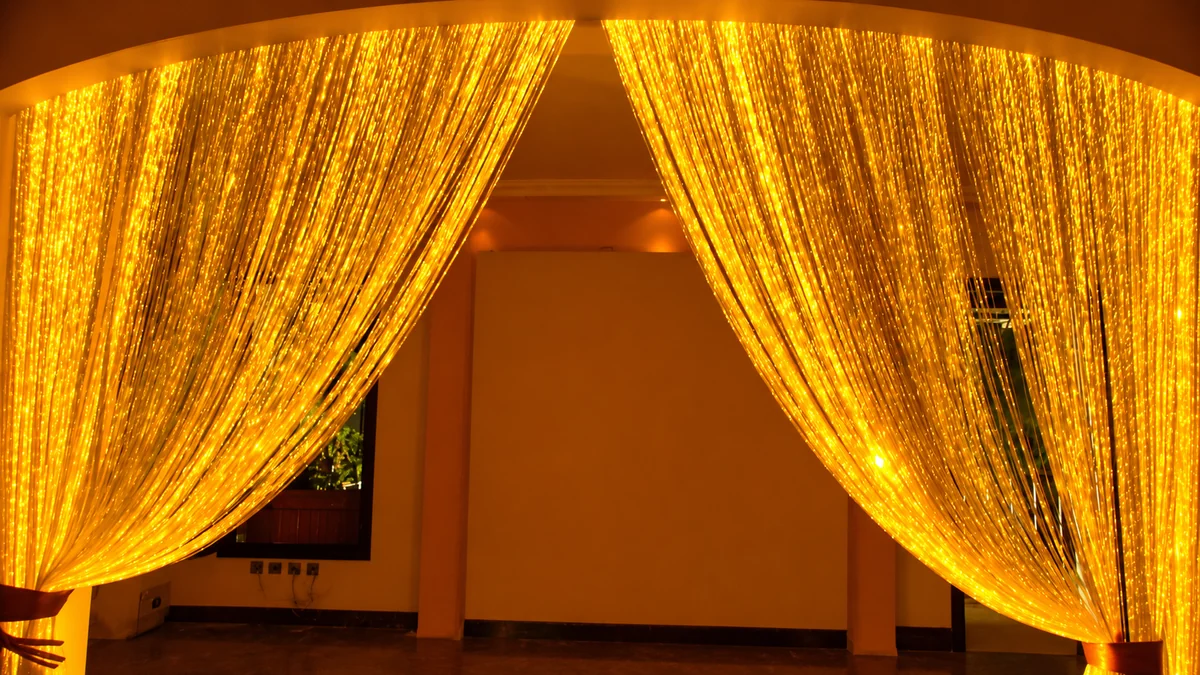 Fibre-optic light curtain glowing gold across an interior threshold
